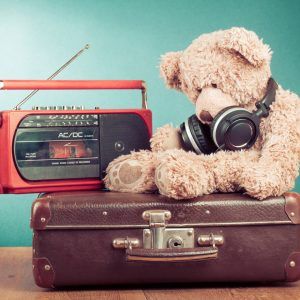 retro radio, teddy bear, head phones and suitcase ready for consumer goods repair service